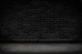 Empty black brick wall and concrete floor for background. Dark room interior with black brick wall blank cement floor for backdrop