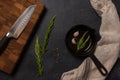 Empty black cast iron frying pan on a dark graphite background