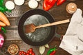 Empty black cast-iron frying pan with a wooden spoon Royalty Free Stock Photo