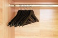 Empty black clothing rack hanging on coathanger in closet Royalty Free Stock Photo