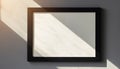 Empty Black Frame on Textured Wall with Sunlight Royalty Free Stock Photo