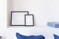 Empty black frames, posters, white canvas, mock up on a white wall, bedroom, gallery template