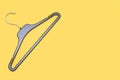 Empty black hanger isolated on a yellow background Royalty Free Stock Photo