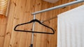 Empty black hanger and white towel in wooden room Royalty Free Stock Photo