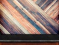 Empty black marble table and blurred diagonal plank wooden wall