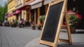 Empty black menu board mockup near restaurant or cafe entrance. Cafe menu on the street, advertising black mockup. Royalty Free Stock Photo