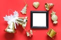 Empty black photo frame and christmas decoration on red background. Royalty Free Stock Photo