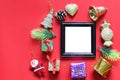 Empty black photo frame and christmas decoration on red background. Royalty Free Stock Photo