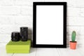 Empty black photo frame on wooden shelf or table. Mockup with copy space. Royalty Free Stock Photo
