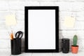 Empty black photo frame on wooden shelf or table. Mockup with copy space. Royalty Free Stock Photo