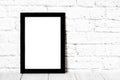 Empty black photo frame on wooden shelf or table. Mockup with copy space. Royalty Free Stock Photo