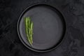 Empty black plate top view on dark textured background. Minimal luxury tableware mockup with copy space Royalty Free Stock Photo