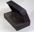 Empty black rectangular cardboard box with partly open lid Royalty Free Stock Photo
