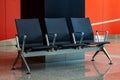 Empty black seats in the waiting hall in the airport Royalty Free Stock Photo