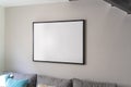 Empty black square frame, poster, white canvas mock up on a gray wall, living room template angle view Royalty Free Stock Photo