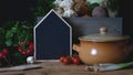 Empty blackboard copy space next to clay cooking pot and fresh vegetable vegetarian home cooking Royalty Free Stock Photo