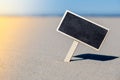 Empty blackboard frame board with copy space for your text or design displays on sandy beach. Summer vacation and Royalty Free Stock Photo