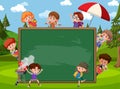 Empty blackboard with many children at the park scene Royalty Free Stock Photo