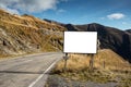 Empty blank billboard mockup, near asphalting road in mountains of Transfagarasan Royalty Free Stock Photo