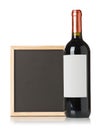 Empty, blank, black chalkboard with red wine bottle over white background Royalty Free Stock Photo