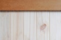 Empty blank brown front page cover of spiral bound notepad on the wooden background Royalty Free Stock Photo