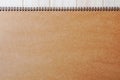 Empty blank brown front page cover of spiral bound notepad on the wooden background Royalty Free Stock Photo