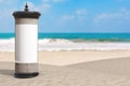 Empty Blank Cylindrical Advertising Column Billboard Mockup with Free Space for Your Design on Summer Sand Ocean Beach. 3d