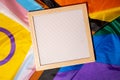 Empty blank frame on Rainbow LGBTQIA flag made from silk material with copy space for your text. Mock up template