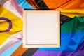 Empty blank frame on Rainbow LGBTQIA flag made from silk material with copy space for your text. Mock up template