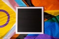 Empty blank frame on Rainbow LGBTQIA flag made from silk material with copy space for your text. Mock up template