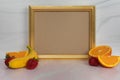 Empty blank gold picture frame with no content assorted fruit banana strawberries oranges