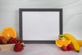 Empty blank gold picture frame with no content assorted fruit banana strawberries oranges