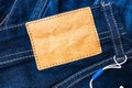 Empty blank leather jeans label sewed on a navy-blue classic jeans. Royalty Free Stock Photo