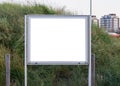 Empty and blank metallic information board to put what ever you want with a green grass hill in the background Royalty Free Stock Photo