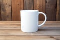 Empty blank mock up of white ceramic coffee mug on wooden table Royalty Free Stock Photo