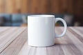 Empty blank mock up of white ceramic coffee mug on wooden table Royalty Free Stock Photo
