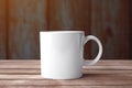 Empty blank mock up of white ceramic coffee mug on wooden table Royalty Free Stock Photo