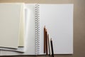 empty blank sheets notebook sketchbook and pencils on gray background Royalty Free Stock Photo