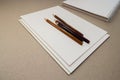 empty blank sheets notebook sketchbook and pencils on gray background Royalty Free Stock Photo