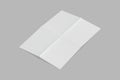 Empty blank white folded paper Mock up isolated on a grey background. Royalty Free Stock Photo