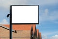 Empty blank white mockup template of a signpost with a brick building in the background. Royalty Free Stock Photo