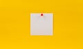 Empty blank white paper note pinned red pin on a yellow background Royalty Free Stock Photo