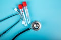 Empty Blood test tube and stethoscope with blue background Royalty Free Stock Photo