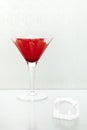 Empty bloody Halloween vampire drink on white background and fangs.