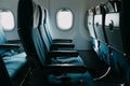 Empty blue air plane seats near windows Royalty Free Stock Photo