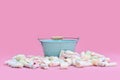 Empty blue bucket surrounded by marshmallow sweets Royalty Free Stock Photo
