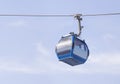 Empty blue cable car on a blue sky background. Royalty Free Stock Photo