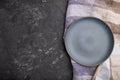 Empty blue ceramic plate on black concrete background. Top view, copy space Royalty Free Stock Photo