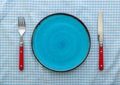 Empty blue ceramic plate with knife and fork Royalty Free Stock Photo