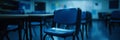 Empty Blue Chairs in a Deserted School Classroom, Evoking a Moody and Somber Atmosphere. Royalty Free Stock Photo